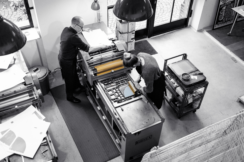 At the printing press at his letterpress workshop p98a in Berlin