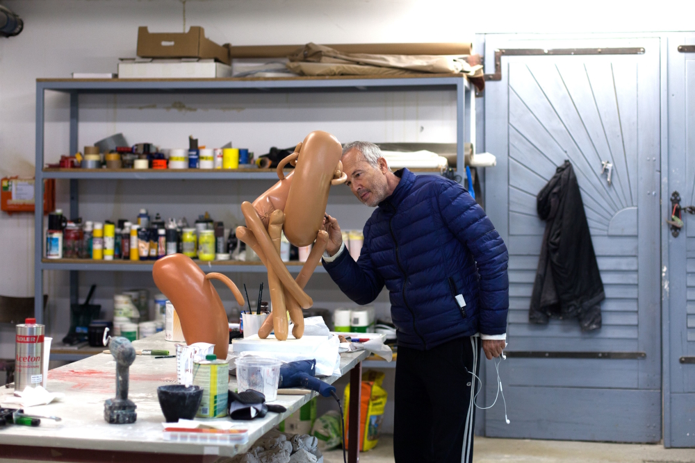 Erwin Wurm in his studio working on one of his abstract sculptures.