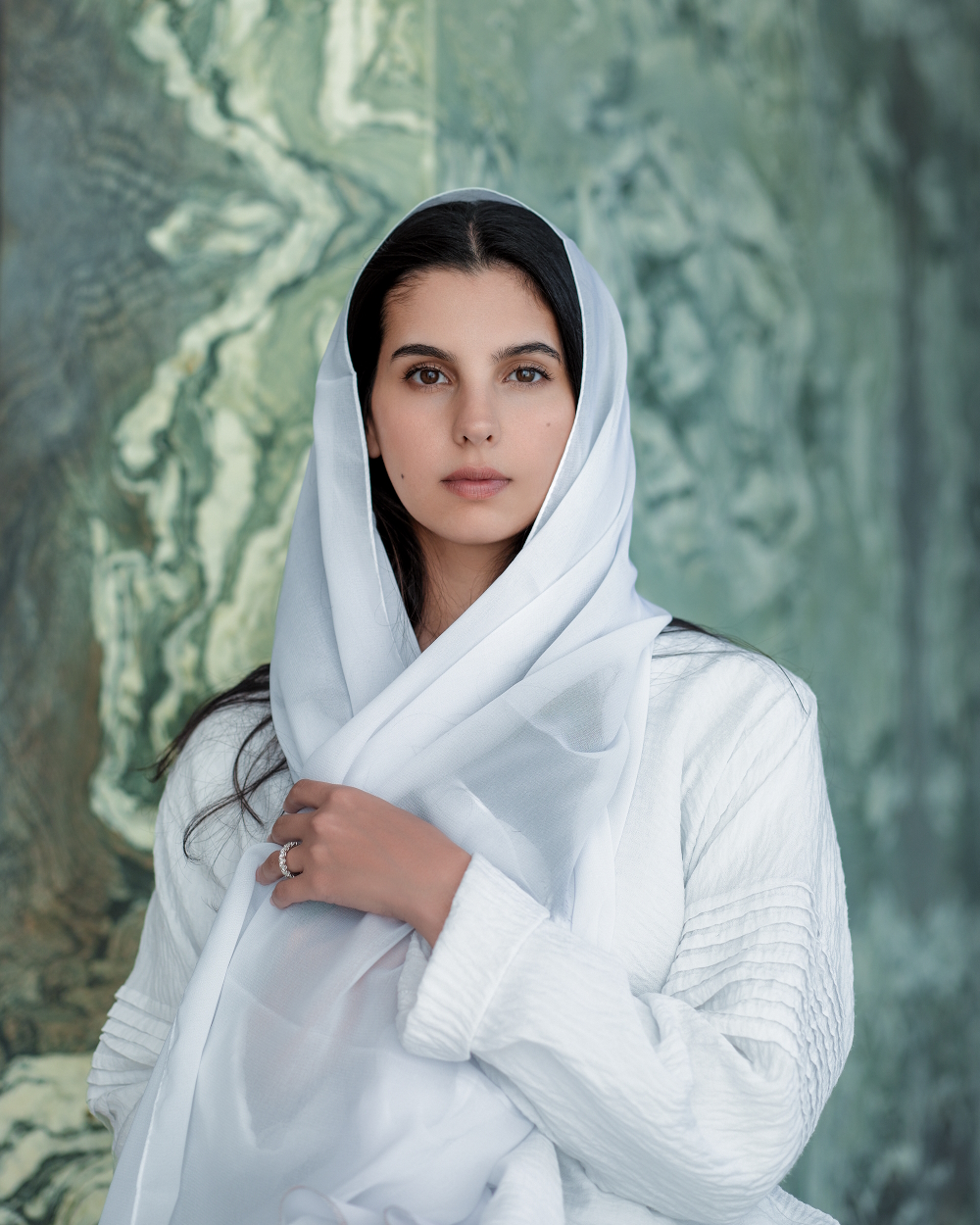 Shahad Alazzaz with an elegant white Hijab, the traditional head covering of a Saudi Arabian woman.