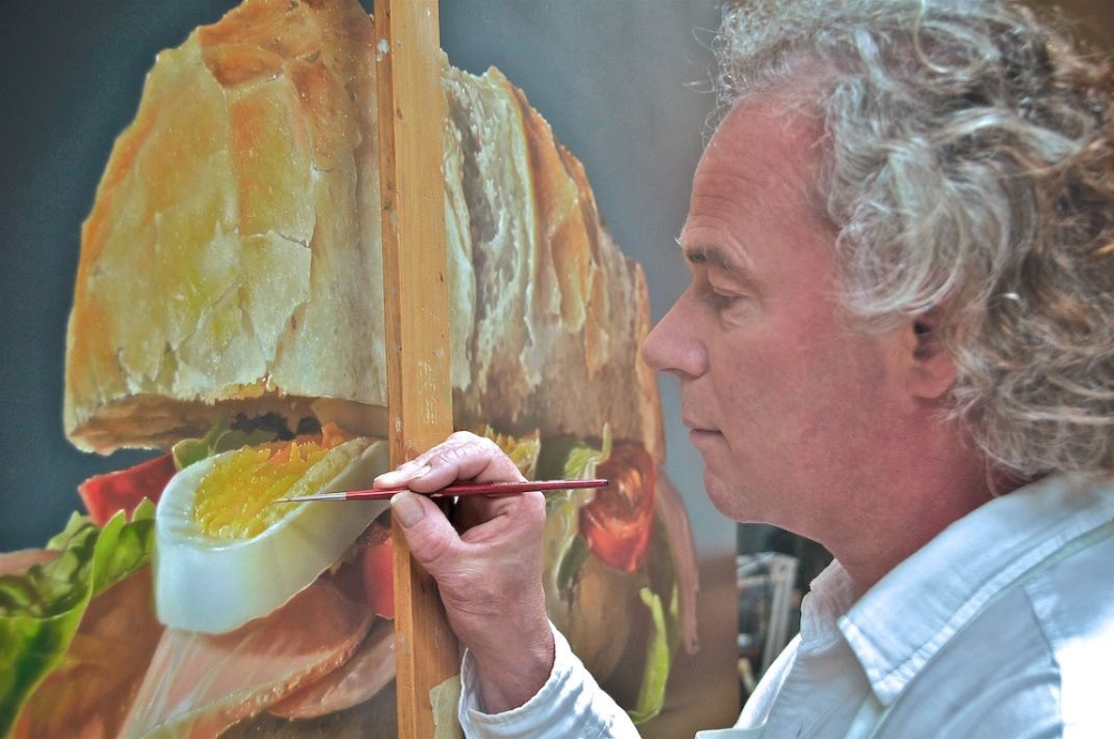 The love for detail is essential for his art: Tjalf Sparnaay working in his studio on the 'Healthy Sandwich' painting.